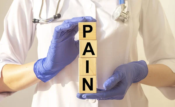 Pain Word Cube Blocks Hands Doctor Blue Protective Gloves Doctor — Stock Photo, Image