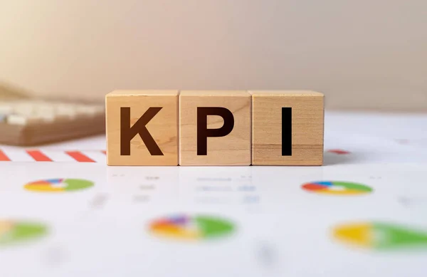 KPI, Key Performance Indicator concept, acronym on wooden cube blocks.