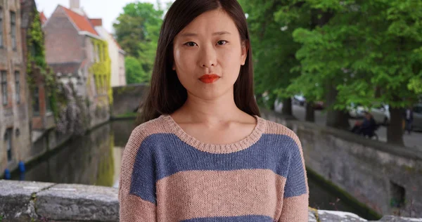 Close-up of confident millennial woman wearing a sweater in Bruges Belgium