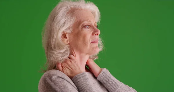 Bejaarde Vrouw Met Pijnlijke Hals Zoek Ongemakkelijk Groen Scherm — Stockfoto