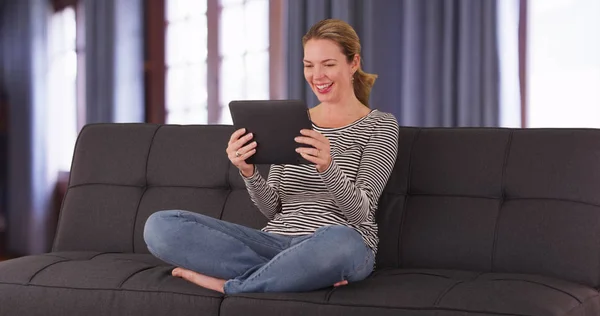 Mulher Branca Sentada Sofá Por Janela Com Cortinas Usando Tablet — Fotografia de Stock