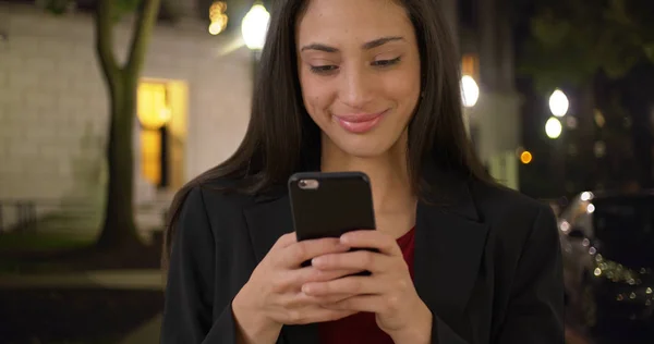 Glimlachend Hispanic Zakenvrouw Teksten Mobiel Apparaat Avond — Stockfoto