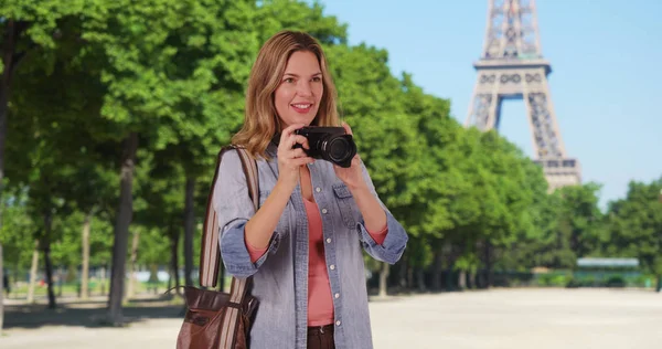 Travel photographer in Paris taking picture outside smiling