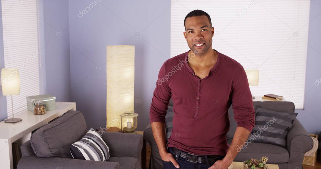 Handsome Black man standing in living room