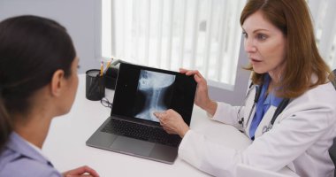 Orta yaşlı Doktor hastaların boyun içinde office x ışınları gözden sıkı atış