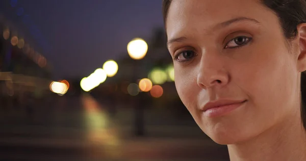 Close up of beautiful Caucasian woman in urban setting with bokeh lights