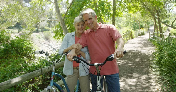 Portrait of married elderly couple on a bike ride