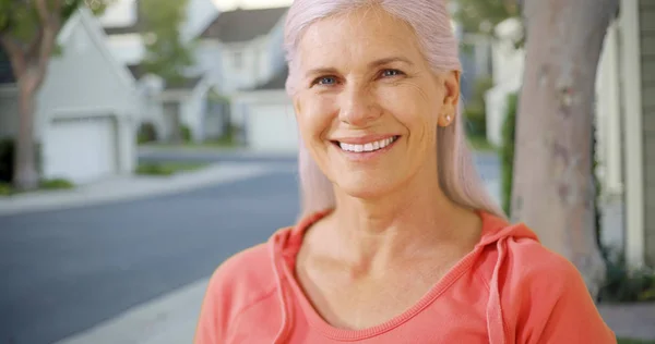 An older woman in her suburban neighborhood