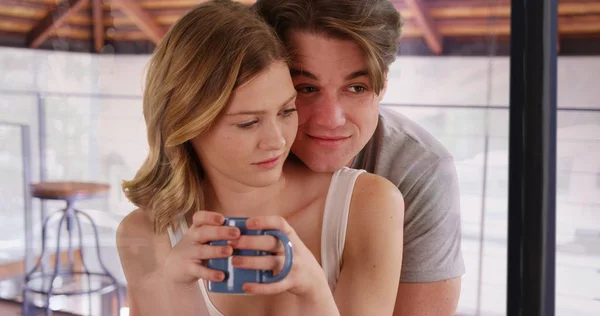 Affectionate Young Couple Drinking Coffee Looking Out Window Home — Stock Photo, Image
