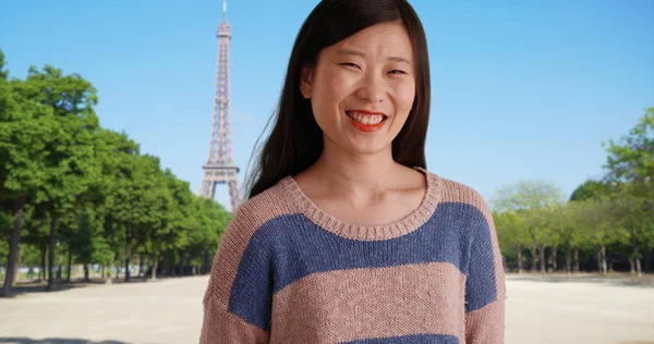 Smiling female millennial looking at camera in Paris France