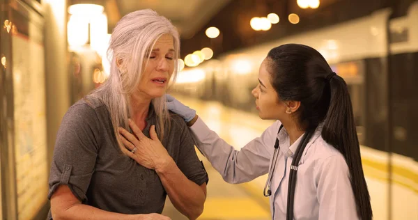 Een Emt Helpt Een Zieke Vrouw Bij Een Treinstation — Stockfoto