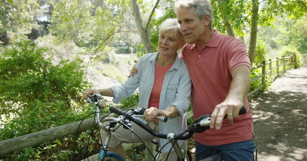 Portrait of mature white couple o bicycles outdoors