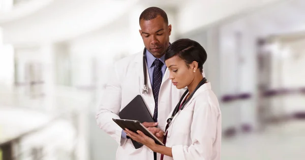 Two Black Doctors Discuss Patient While Tablets — Stock Photo, Image