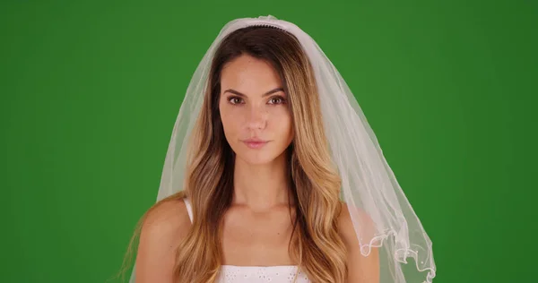 美丽的女性千禧年站在婚纱和绿色屏幕上的面纱 — 图库照片