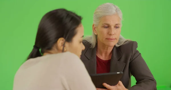 Business executive has a meeting with her employee on green screen