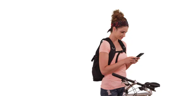 Portrait of Caucasian woman sending text next to bicycle on white background