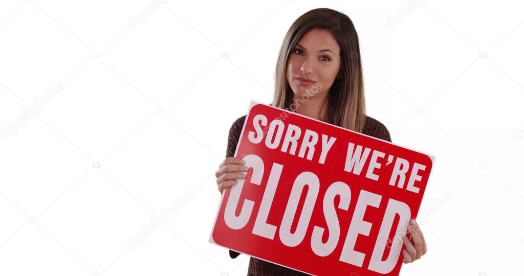 Caucasian Woman holding Closed sign standing on solid white background