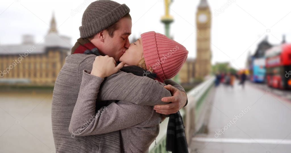 Happy Caucasian couple on Westminster Bridge looking into each others eyes 
