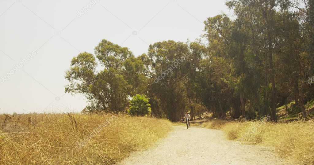 Mexican man riding bicycle on trail