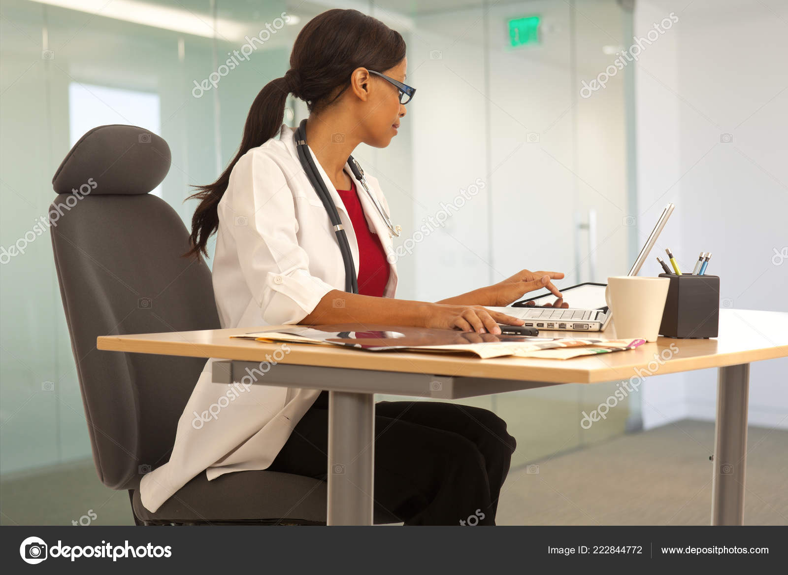 Professional Female Medical Doctor Working Her Desk Using Laptop