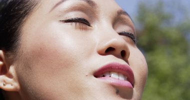 Genç kadın yüzüne güneş ile çalışan bir mola