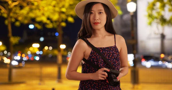 Close up of Asian millennial tourist taking photo in Paris France
