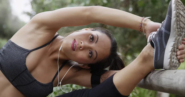 Healthy Asian woman stretching at the park