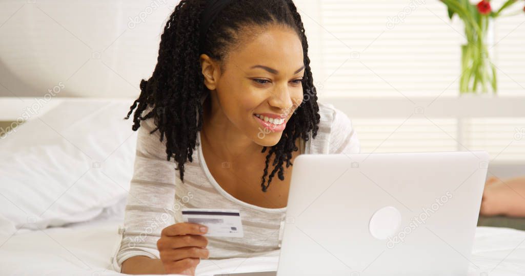 Black woman typing in credit card number