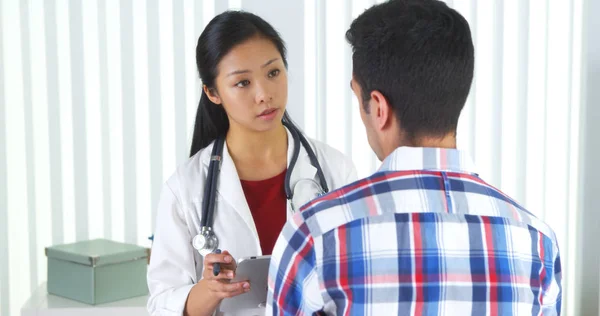 Asian Doctor Asking Patient Questions Taking Notes — Stock Photo, Image