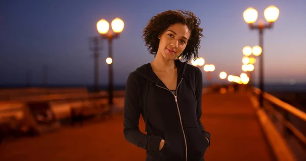 Lovely black woman standing on pier