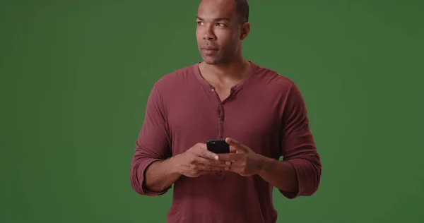 Black Man Texts His Mobile Phone Green Screen — Stock Photo, Image