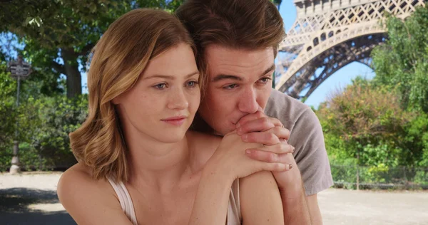 Portrait of young Caucasian couple in Paris relaxing outdoors smiling