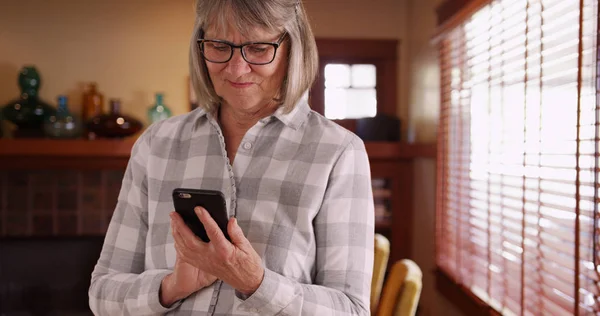 Happy Senior Person Texting Cell Phone Window Her Home — Stock Photo, Image