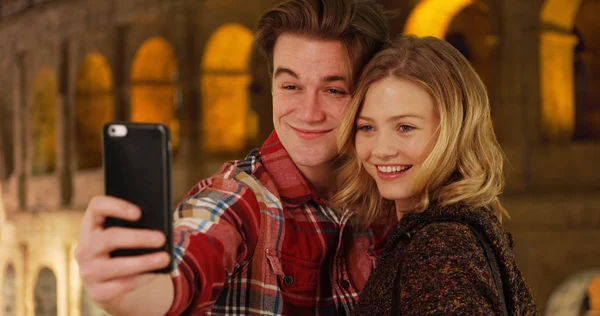 Cheerful Young Couple Taking Selfie Front Coliseum Night — Stock Photo, Image
