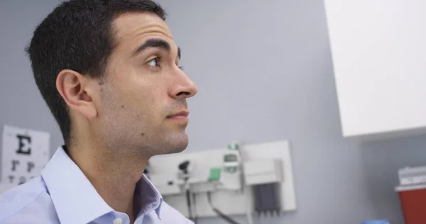 Close up of hispanic patient waiting in doctors office for checkup