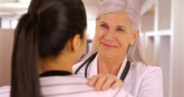 A happy doctor talks to a patient at the hostpital