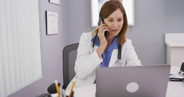 Close up of medical physician discussing with patient on phone her test results