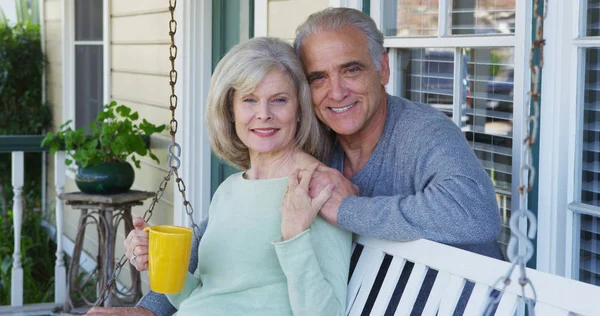 Elderly Couple Smiling Porch Looking Camera — Stock Photo, Image
