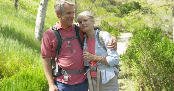 Healthy white couple enjoying a hike