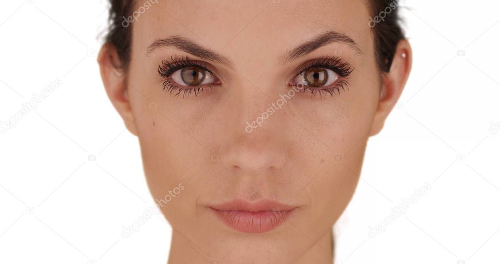 Close-up of pretty female on white copy space looking intently at camera alone