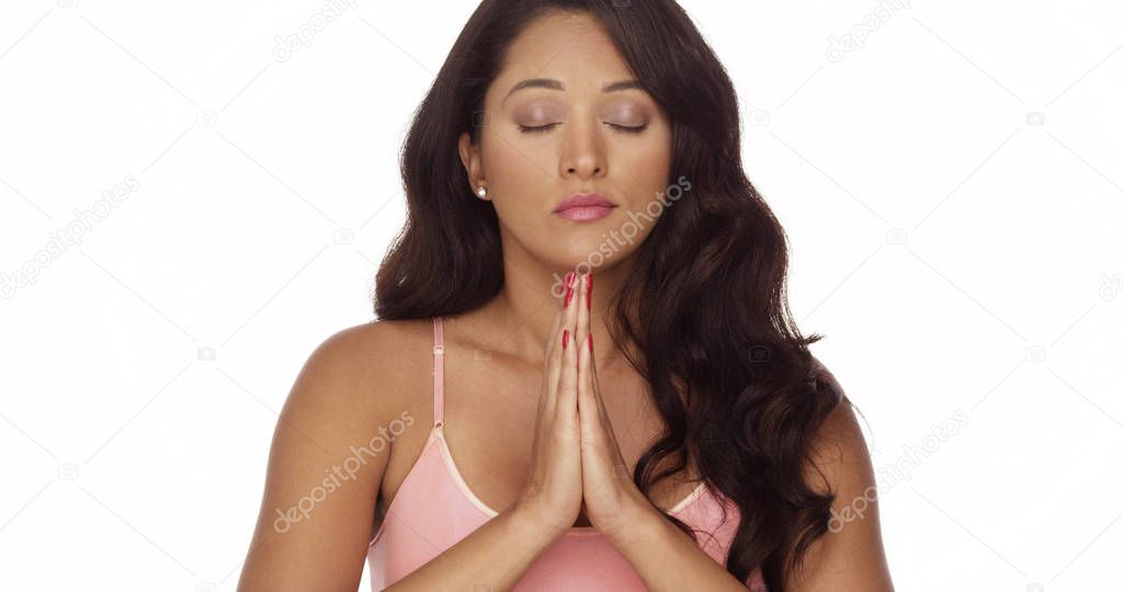 Mexican woman meditating on white background