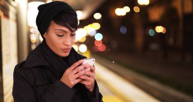 Kadın kentsel şehir Metro metro platformda gece manifatura Smartphone cep telefonu ile