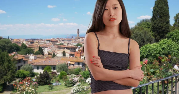 Close up of Asian millennial posing with arms crossed in Florence Italy