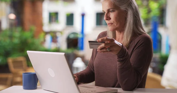Mature Caucasian Woman Types Credit Card Information Laptop — Stock Photo, Image