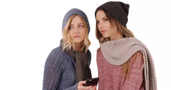 Paire Filles Vêtements Hiver Naviguant Téléphone Sur Espace Copie Blanche — Photo