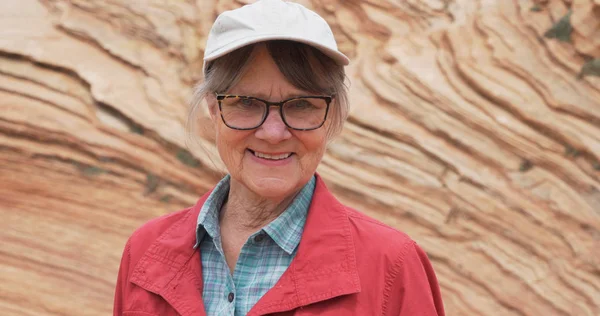 Smiling Elderly Woman Looking Camera Front Rocky Sandstone Cliff — Stock Photo, Image