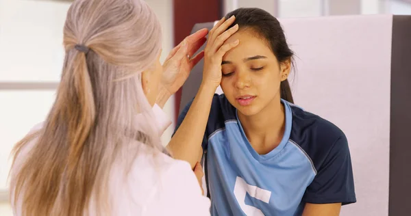 A young soccer player with a head injury recieves medical attention