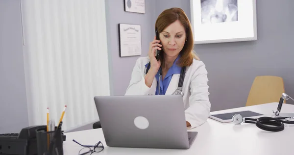 Senior Medical Physician Talking Smart Phone Using Laptop Computer — Stock Photo, Image