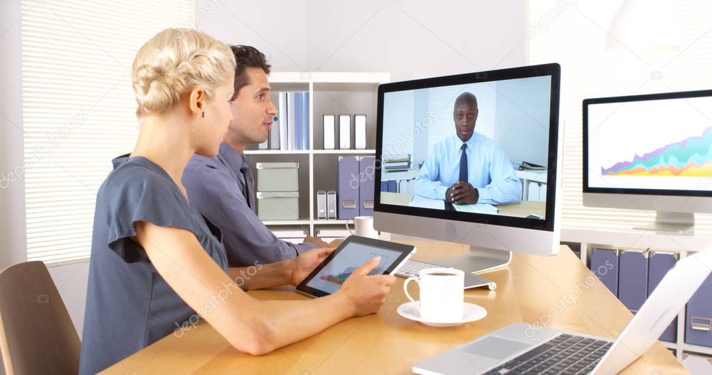 African businessman remotely having a discussion with colleagues