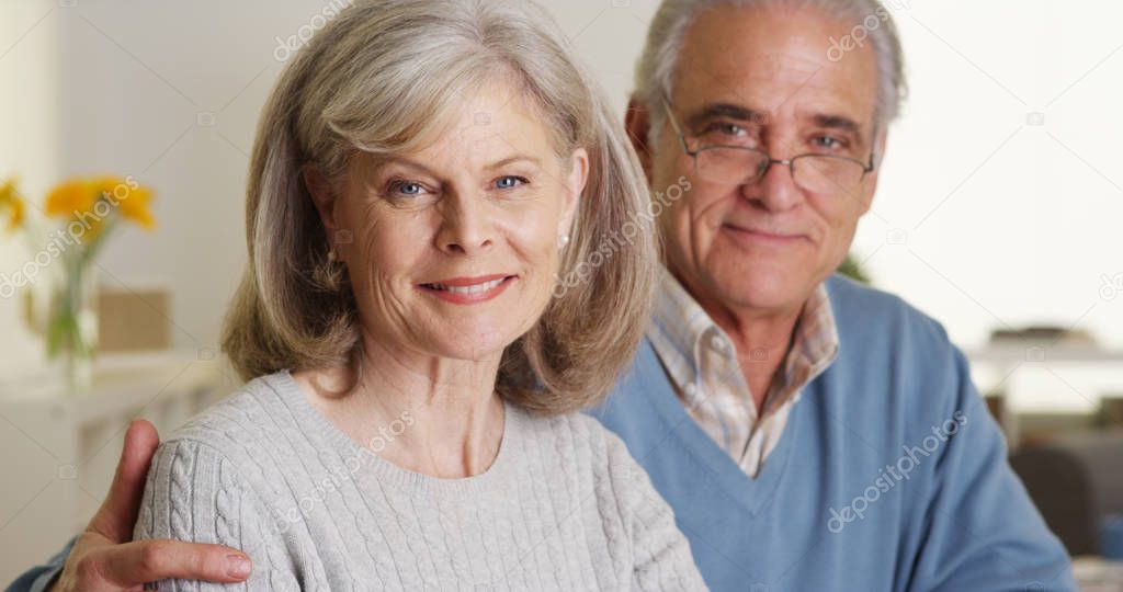 Mature couple smiling indoors
